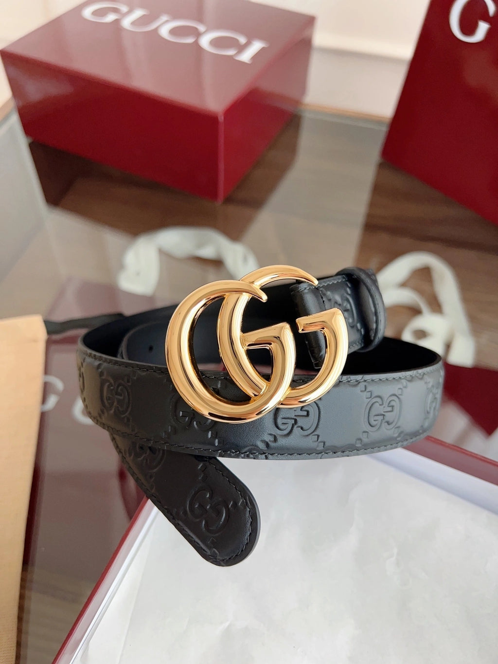 Black leather belt with gold GG buckle